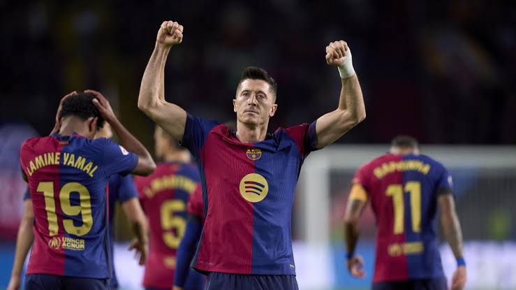 Barcelona's Robert Lewandowski scores one of his two goals against Sevilla at Olimpic Lluis Companys Stadium